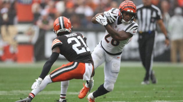 Joe Mixon #28 of the Cincinnati Bengals runs the ball against Denzel Ward #21 of the Cleveland Browns during the second half at Cleveland Browns Stadium on September 10, 2023 in Cleveland, Ohio.