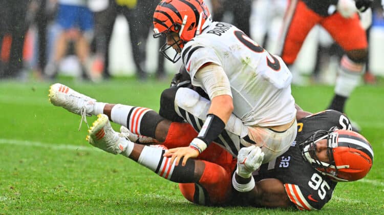 Joe Burrow #9 of the Cincinnati Bengals is sacked by Myles Garrett #95 of the Cleveland Browns during the second half at Cleveland Browns Stadium on September 10, 2023 in Cleveland, Ohio.