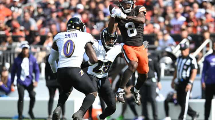 Elijah Moore #8 of the Cleveland Browns catches a pass in front of Roquan Smith #0 of the Baltimore Ravens and Ronald Darby #28 of the Baltimore Ravens during the second half at Cleveland Browns Stadium on October 01, 2023 in Cleveland, Ohio.