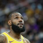 LeBron James #23 of the Los Angeles Lakers stands on the court during a break in the first quarter of a preseason game against the Brooklyn Nets at T-Mobile Arena on October 09, 2023 in Las Vegas, Nevada. The Lakers defeated the Nets 129-126.