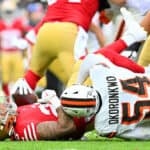 Ogbo Okoronkwo #54 of the Cleveland Browns tackles Elijah Mitchell #25 of the San Francisco 49ers during the third quarter at Cleveland Browns Stadium on October 15, 2023 in Cleveland, Ohio.