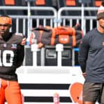 P J. Walker #10 of the Cleveland Browns. and Deshaun Watson #4 of the Cleveland Browns look on during the third quarter against the Baltimore Ravens at Cleveland Browns Stadium on October 01, 2023 in Cleveland, Ohio.