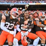 Ronnie Hickman #33, Martin Emerson Jr. #23, and Greg Newsome II #0 of the Cleveland Browns celebrate with fans after beating the Pittsburgh Steelers 13-10 at Cleveland Browns Stadium on November 19, 2023 in Cleveland, Ohio.