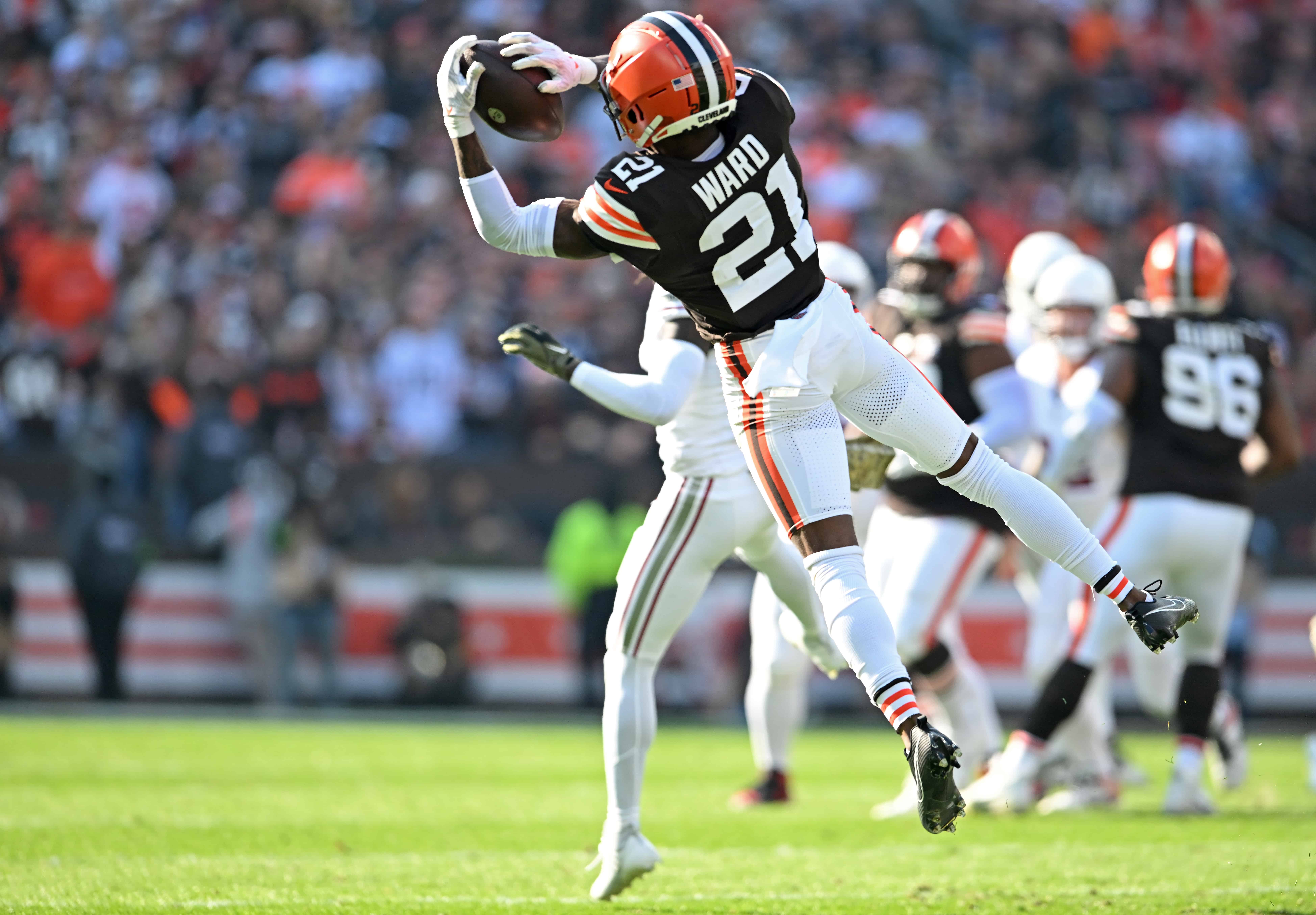 CLEVELAND, OHIO - NOVEMBER 05: Denzel Ward #21 of the Cleveland Browns intercepts a pass against the Arizona Cardinals during the first half of the game at Cleveland Browns Stadium on November 05, 2023 in Cleveland, Ohio.