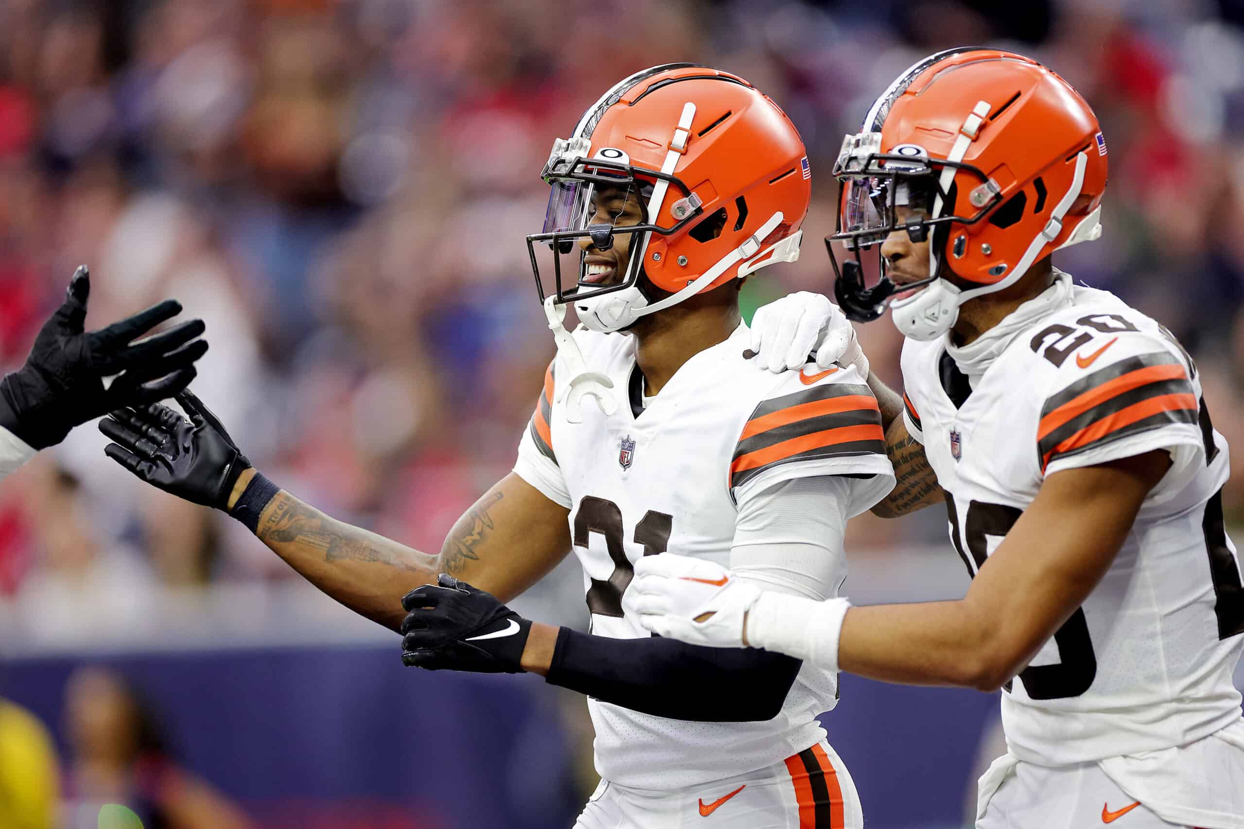 HOUSTON, TEXAS - DECEMBER 04: Denzel Ward #21 of the Cleveland Browns and Greg Newsome II #20 of the Cleveland Browns celebrate after Ward's fumble recovery for a touchdown during the third quarter against the Houston Texans at NRG Stadium on December 04, 2022 in Houston, Texas.