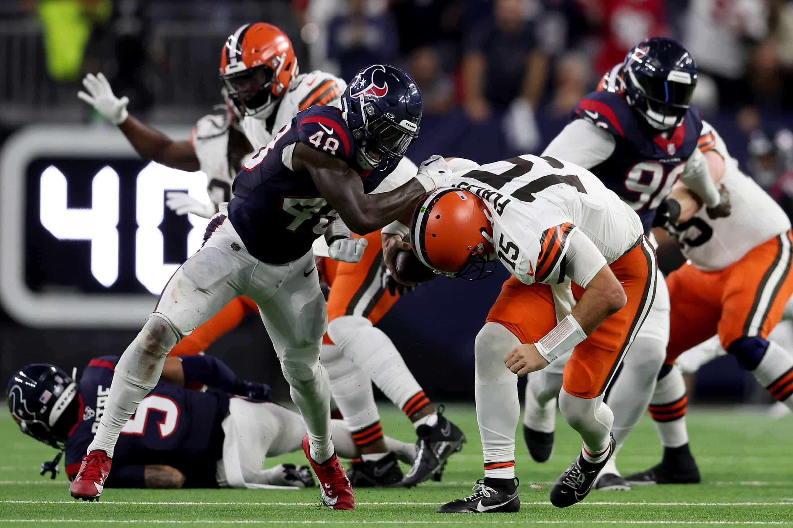 HOUSTON, TEXAS - JANUARY 13: Christian Harris #48 of the Houston Texans sacks Joe Flacco #15 of the Cleveland Browns during the third quarter in the AFC Wild Card Playoffs at NRG Stadium on January 13, 2024 in Houston, Texas.