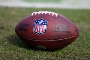 A detailed view of the NFL logo on a football prior to the game between the Minnesota Vikings and the Chicago Bears at Soldier Field on October 15, 2023 in Chicago, Illinois.