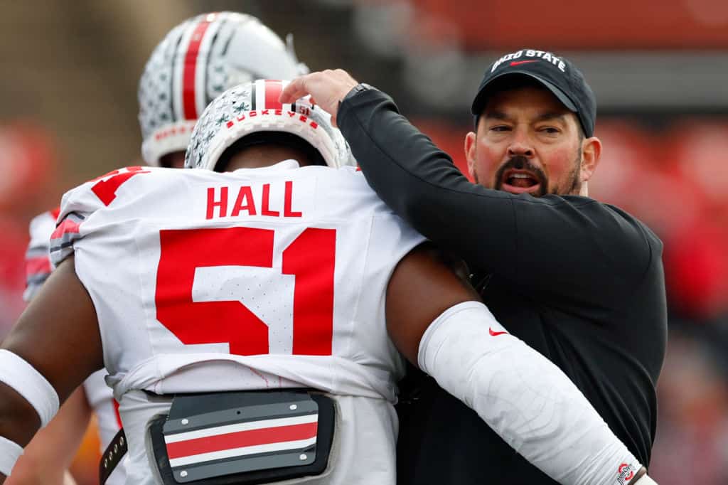 Head coach Ryan Day of the Ohio State Buckeyes hugs defensive tackle Michael Hall Jr. #51 before a college football game against the Rutgers Scarlet Knights at SHI Stadium on November 4, 2023 in Piscataway, New Jersey.