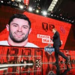 NFL Commissioner Roger Goodell walks past a video board displaying an image of Baker Mayfield of Oklahoma after he was picked #1 overall by the Cleveland Browns during the first round of the 2018 NFL Draft at AT&T Stadium on April 26, 2018 in Arlington, Texas.