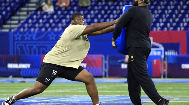INDIANAPOLIS, INDIANA - MARCH 03: Javion Cohen #OL10 of Miami-Fl participates in a drill during the NFL Combine at Lucas Oil Stadium on March 03, 2024 in Indianapolis, Indiana.