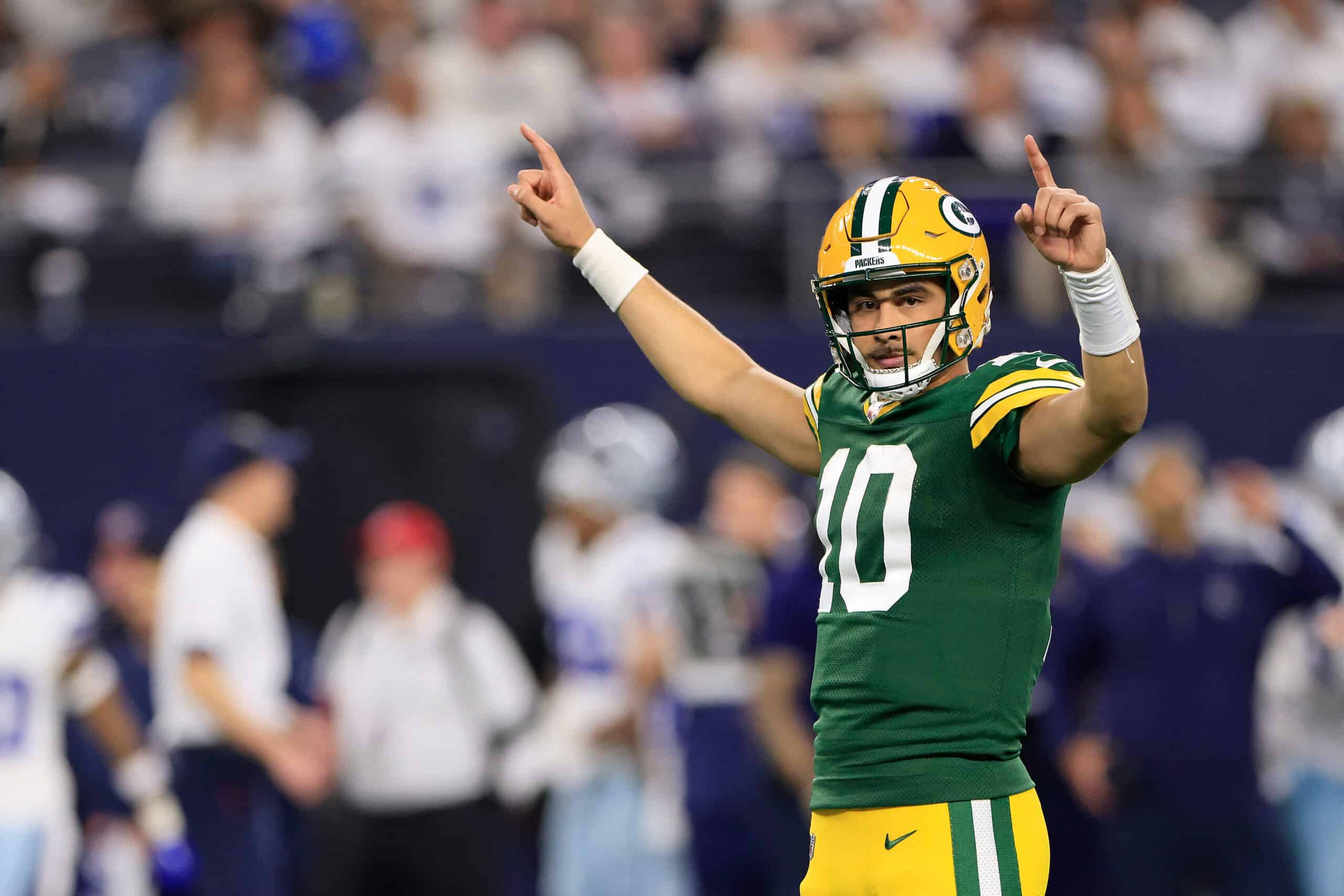 ARLINGTON, TEXAS - JANUARY 14: Jordan Love #10 of the Green Bay Packers celebrates a touchdown against the Dallas Cowboys during the third quarter of the NFC Wild Card Playoff game at AT&T Stadium on January 14, 2024 in Arlington, Texas.