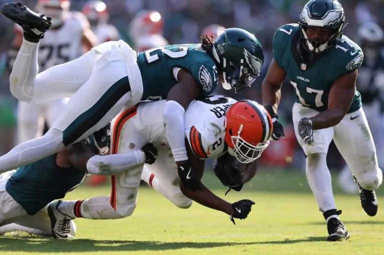 PHILADELPHIA, PENNSYLVANIA - OCTOBER 13: Kelee Ringo #22 of the Philadelphia Eagles tackles Amari Cooper #2 of the Cleveland Browns during the fourth quarter at Lincoln Financial Field on October 13, 2024 in Philadelphia, Pennsylvania.