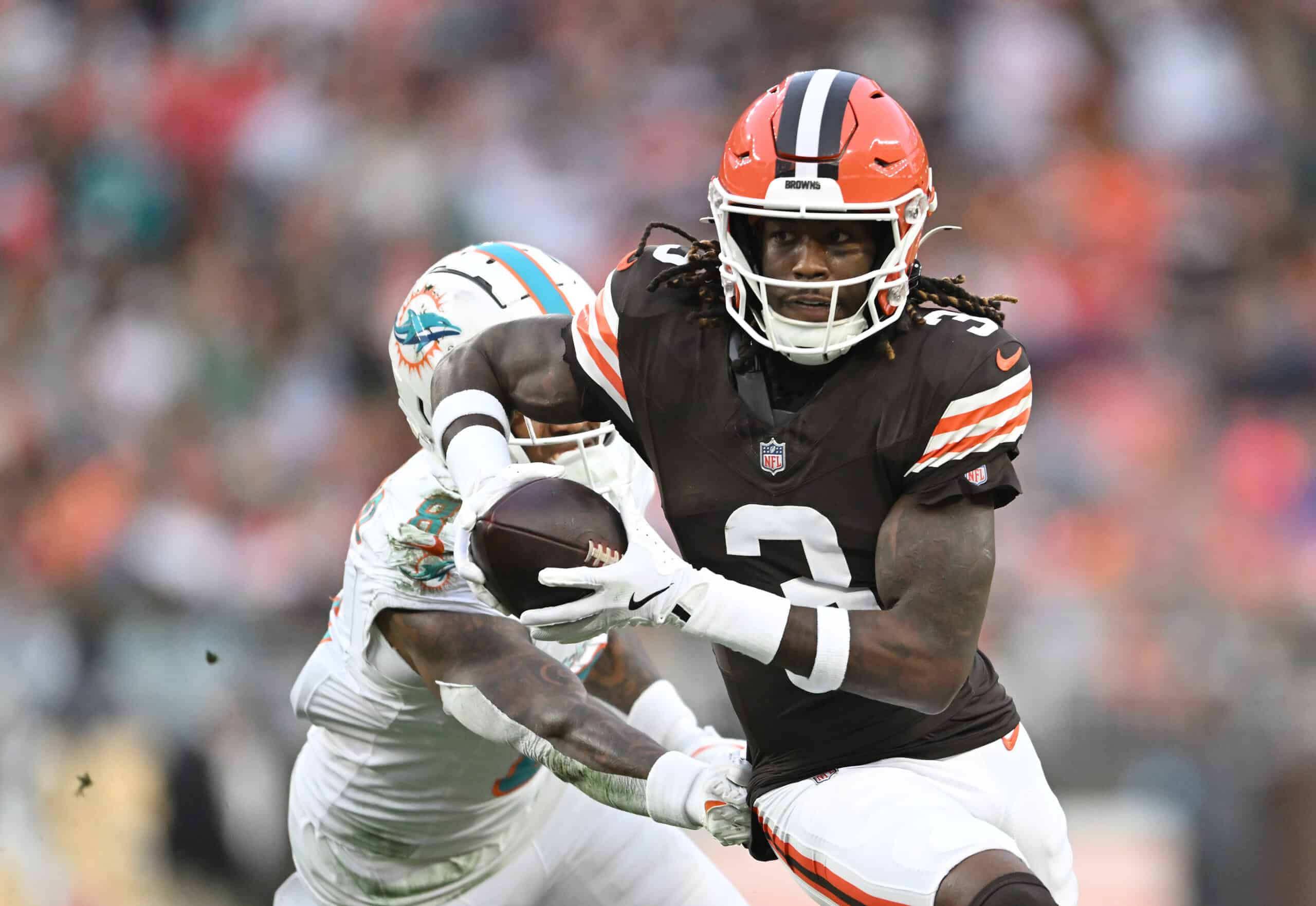 CLEVELAND, OHIO - DECEMBER 29: Jerry Jeudy #3 of the Cleveland Browns catches the ball against Jevon Holland #8 of the Miami Dolphins in the first quarter at Huntington Bank Field on December 29, 2024 in Cleveland, Ohio.
