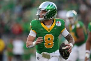 PASADENA, CALIFORNIA - JANUARY 01: Dillon Gabriel #8 of the Oregon Ducks scrambles with the ball during the Rose Bowl game against the Ohio State Buckeyes at Rose Bowl Stadium on January 01, 2025 in Pasadena, California.