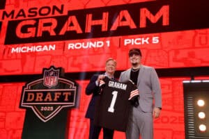 GREEN BAY, WISCONSIN - APRIL 24: Defensive Tackle Mason Graham of Michigan poses with NFL Commissioner Roger Goodell after being selected fifth overall pick by the Cleveland Browns during the first round of the 2025 NFL Draft at Lambeau Field on April 24, 2025 in Green Bay, Wisconsin.