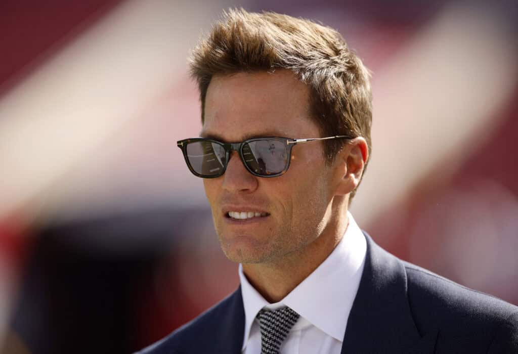 TAMPA, FLORIDA - JANUARY 05: Broadcaster Tom Brady looks on during warm ups prior to the game between the New Orleans Saints and the Tampa Bay Buccaneers at Raymond James Stadium on January 05, 2025 in Tampa, Florida.