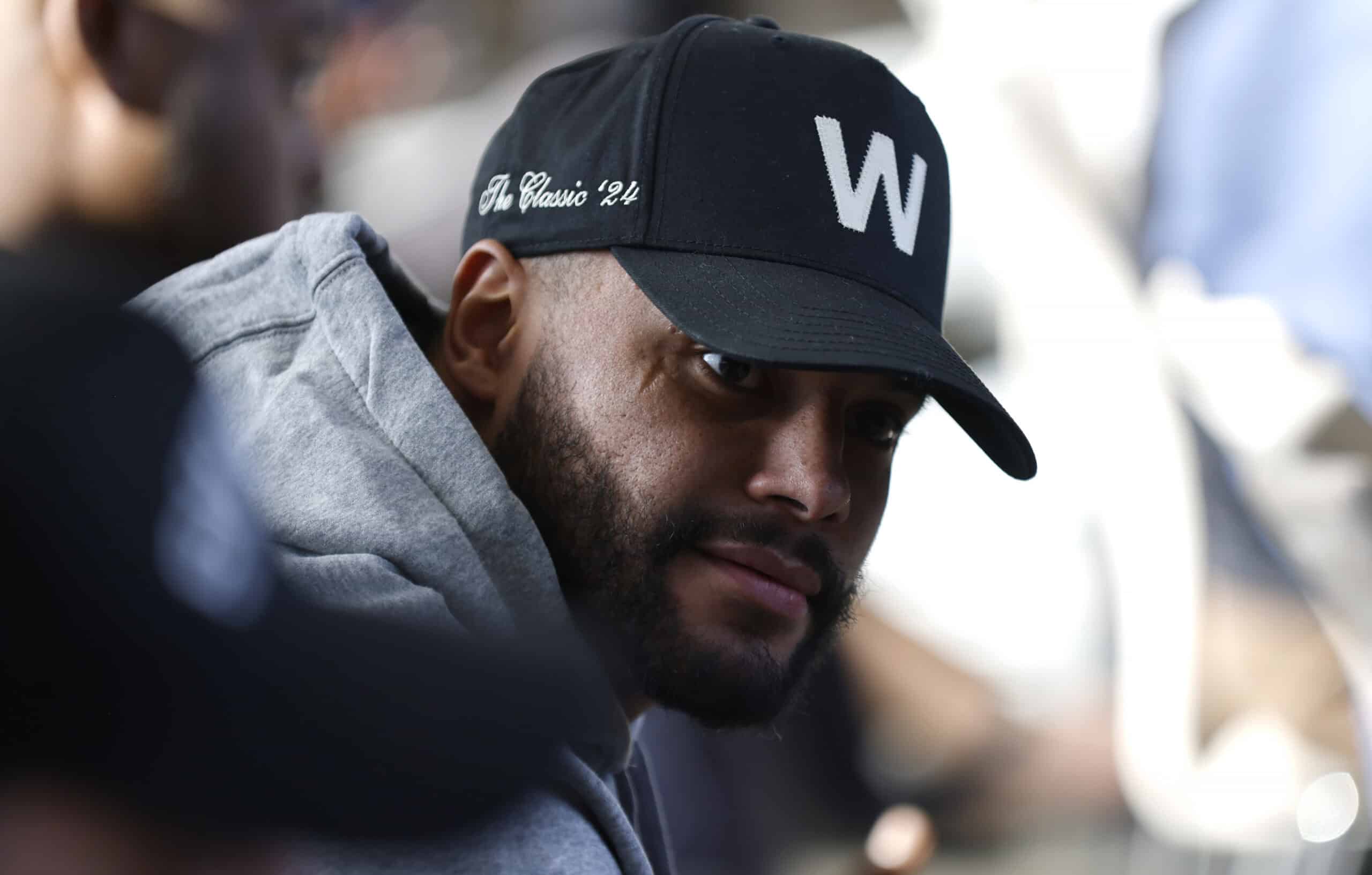 FRISCO, TEXAS - JANUARY 27: Dallas Cowboys quarterback Dak Prescott #4 looks on from the audience as Brian Schottenheimer is introduced as the new head coach of the Dallas Cowboys at The Star in Frisco on January 27, 2025 in Frisco, Texas.
