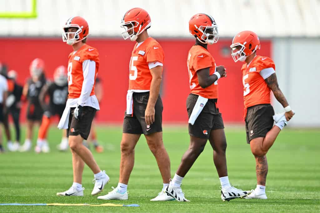 BEREA, OHIO - JUNE 12: Quarterbacks Kenny Pickett #8 Joe Flacco #15 Shedeur Sanders #12 Dillon Gabriel #5 of the Cleveland Browns warm up before organized team activities at CrossCountry Mortgage Campus on June 12, 2025 in Berea, Ohio.