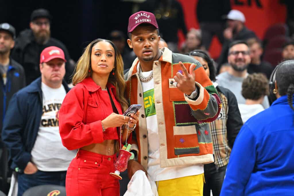 CLEVELAND, OHIO - APRIL 18: Jilly Anais and Quarterback Deshaun Watson of the Cleveland Browns talk after Game Two of the Eastern Conference First Round Playoffs between the Cleveland Cavaliers and the New York Knicks at Rocket Mortgage Fieldhouse on April 18, 2023 in Cleveland, Ohio. The Cavaliers defeated the Knicks 107-90.