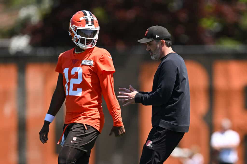BEREA, OHIO - MAY 10: Head coach Kevin Stefanski of the Cleveland Browns instructs Shedeur Sanders #12 during rookie minicamp at CrossCountry Mortgage Campus on May 10, 2025 in Berea, Ohio.