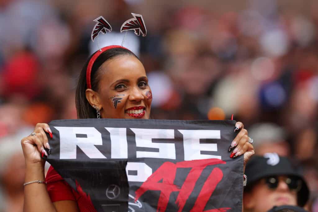 ATLANTA, GEORGIA - OCTOBER 02: An Atlanta Falcons fan smiles for a picture during the third quarter of the game against the Cleveland Browns at Mercedes-Benz Stadium on October 02, 2022 in Atlanta, Georgia.