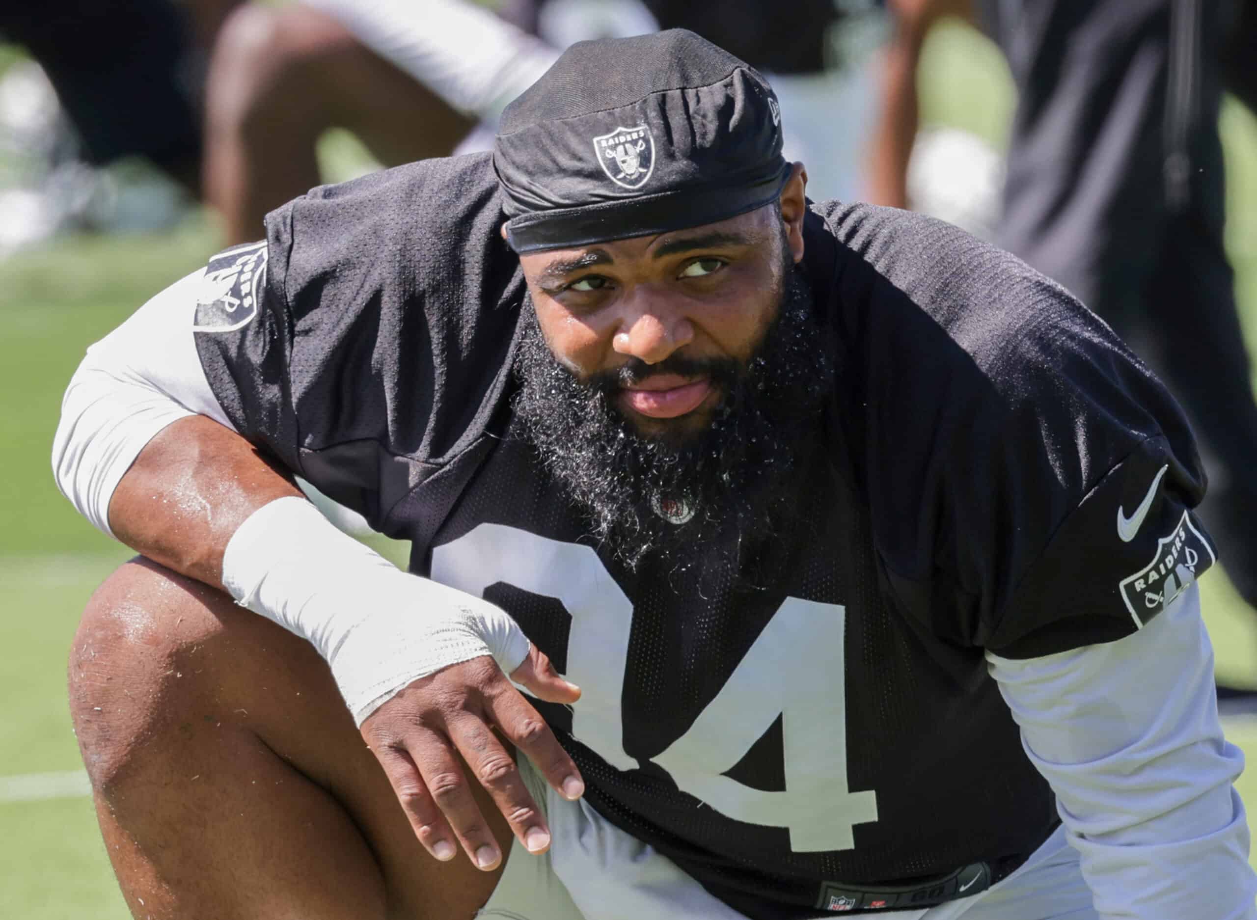 HENDERSON, NEVADA - MAY 29: Defensive tackle Christian Wilkins #94 of the Las Vegas Raiders stretches during an OTA offseason workout at the Las Vegas Raiders Headquarters/Intermountain Healthcare Performance Center on May 29, 2024 in Henderson, Nevada.