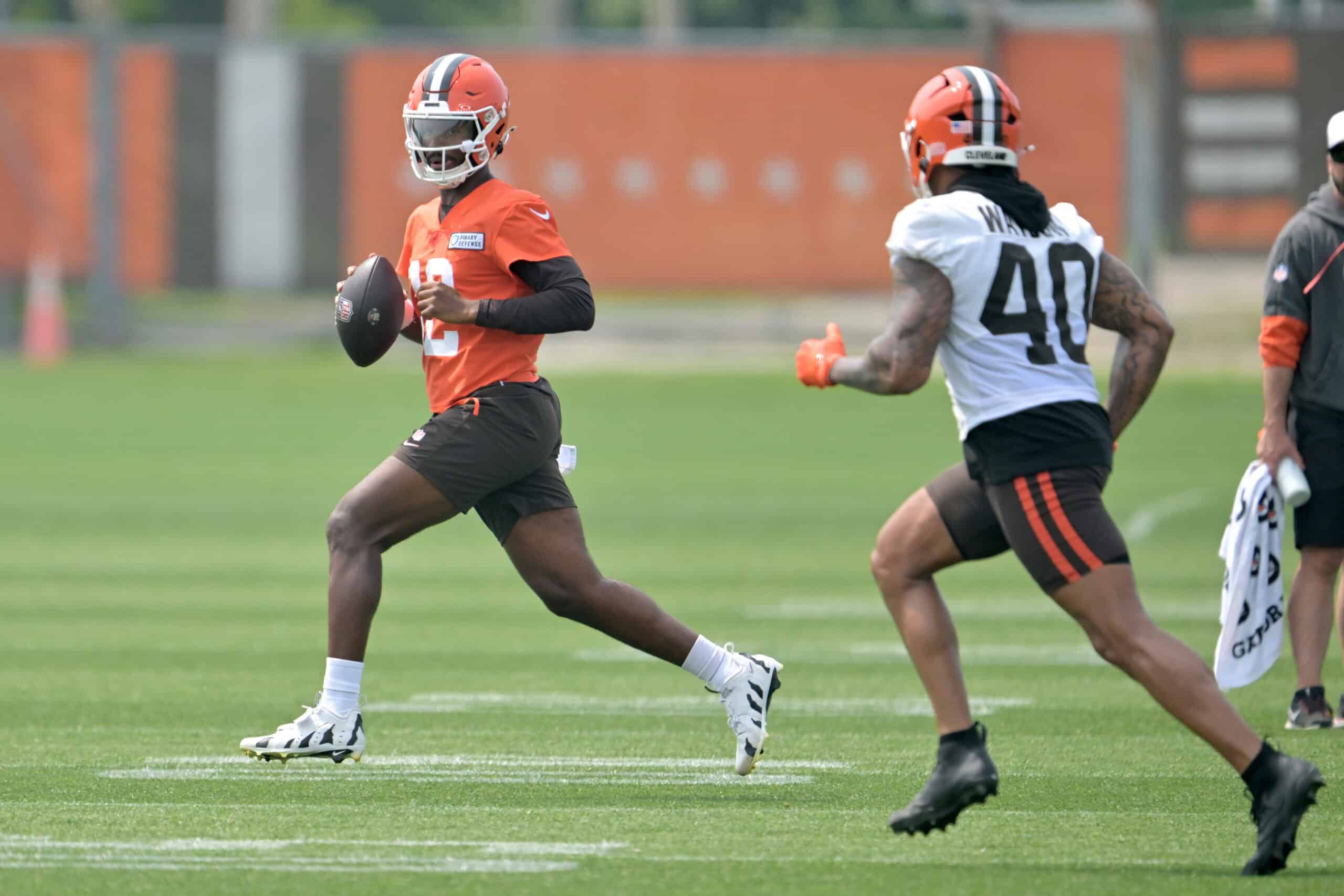 BEREA, OHIO - JUNE 12: Quarterback Shedeur Sanders #12 and linebacker Nathaniel Watson #40 of the Cleveland Browns run a play during organized team activities at CrossCountry Mortgage Campus on June 12, 2025 in Berea, Ohio.