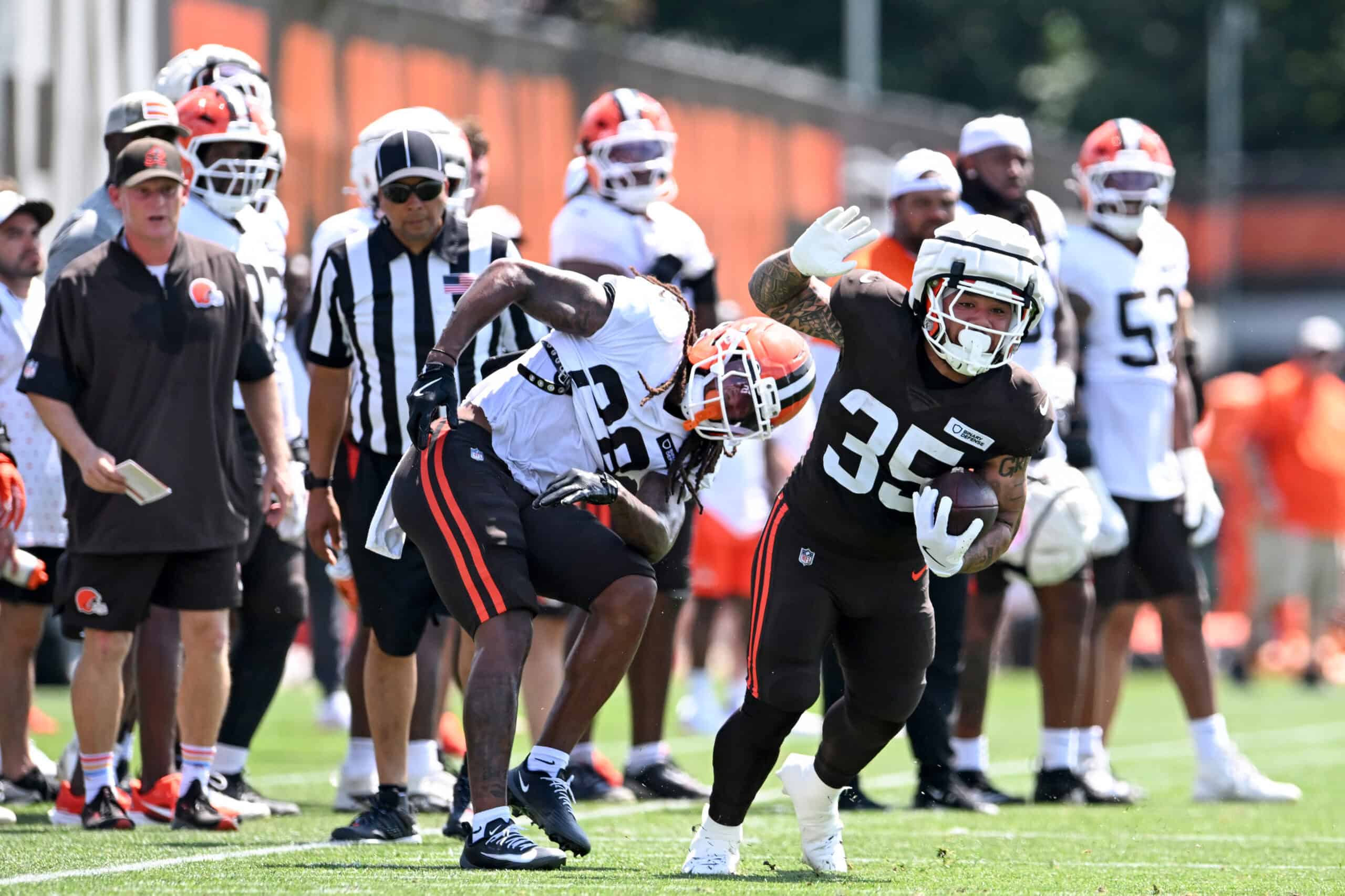 BEREA, OHIO - JULY 28: Toa Taua #35 of the Cleveland Browns breaks a tackle by Rayshawn Jenkins #28 during Cleveland Browns training camp at CrossCountry Mortgage Campus on July 28, 2025 in Berea, Ohio.