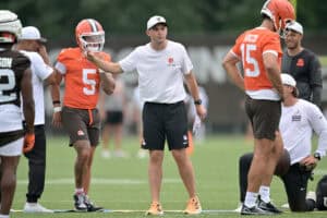 BEREA, OHIO - JULY 25: Offensive coordinator Tommy Rees works with quarterbacks Dillon Gabriel #5 and Joe Flacco #15 of the Cleveland Browns during training camp at CrossCountry Mortgage Campus on July 25, 2025 in Berea, Ohio.