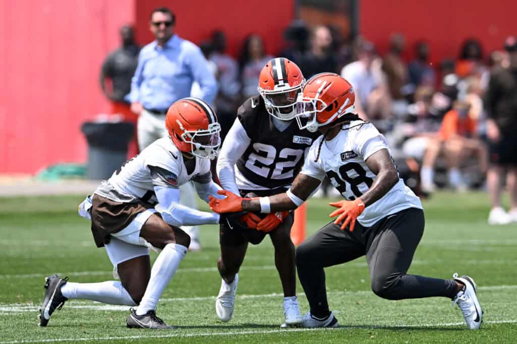 BEREA, OHIO - JUNE 04: Denzel Ward #21 and Rayshawn Jenkins #28 of the Cleveland Browns break up a pass intended for Dylan Sampson #22 during Cleveland Browns OTA offseason workouts at CrossCountry Mortgage Campus on June 04, 2025 in Berea, Ohio.