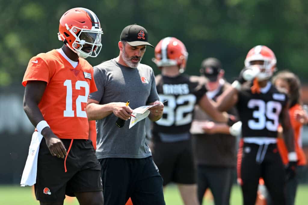 BEREA, OHIO - JUNE 11: Head coach Kevin Stefanski of the Cleveland Browns instructs Shedeur Sanders #12 during Cleveland Browns mandatory minicamp at CrossCountry Mortgage Campus on June 11, 2025 in Berea, Ohio.
