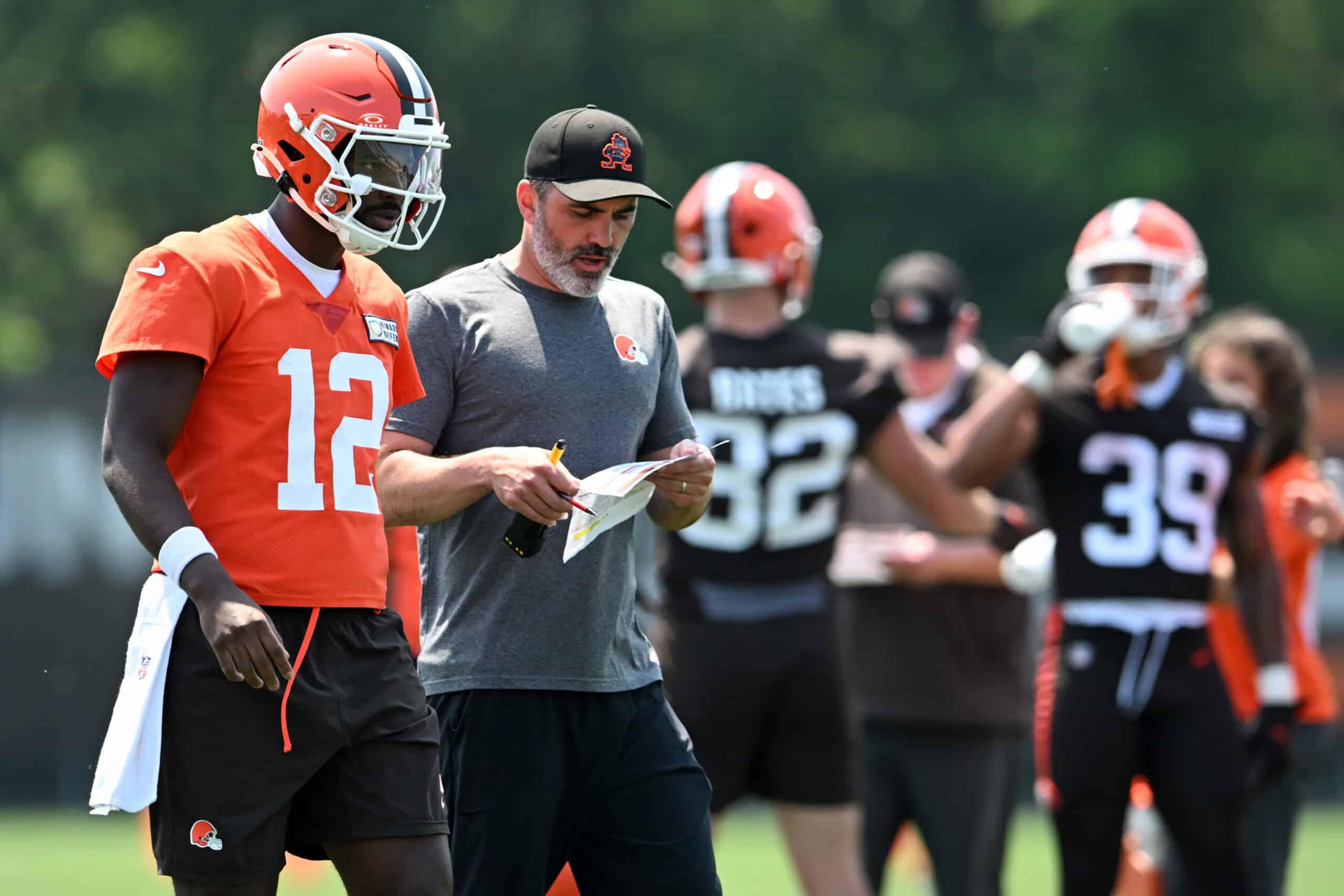 BEREA, OHIO - JUNE 11: Head coach Kevin Stefanski of the Cleveland Browns instructs Shedeur Sanders #12 during Cleveland Browns mandatory minicamp at CrossCountry Mortgage Campus on June 11, 2025 in Berea, Ohio.