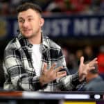 ATLANTA, GEORGIA - DECEMBER 03: Football Quarterback Johnny Manziel talks onset prior to the SEC Championship game between the LSU Tigers and the Georgia Bulldogs at Mercedes-Benz Stadium on December 03, 2022 in Atlanta, Georgia.