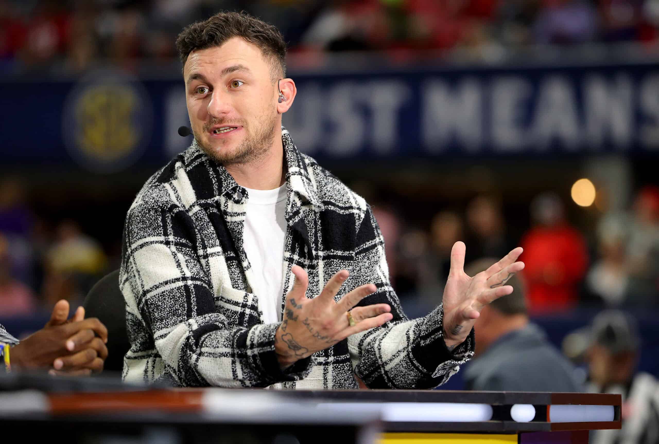 ATLANTA, GEORGIA - DECEMBER 03: Football Quarterback Johnny Manziel talks onset prior to the SEC Championship game between the LSU Tigers and the Georgia Bulldogs at Mercedes-Benz Stadium on December 03, 2022 in Atlanta, Georgia.
