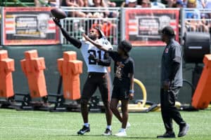 BEREA, OHIO - JULY 28: Denzel Ward #21 of the Cleveland Browns catches a pass against a fan during Cleveland Browns training camp at CrossCountry Mortgage Campus on July 28, 2025 in Berea, Ohio.