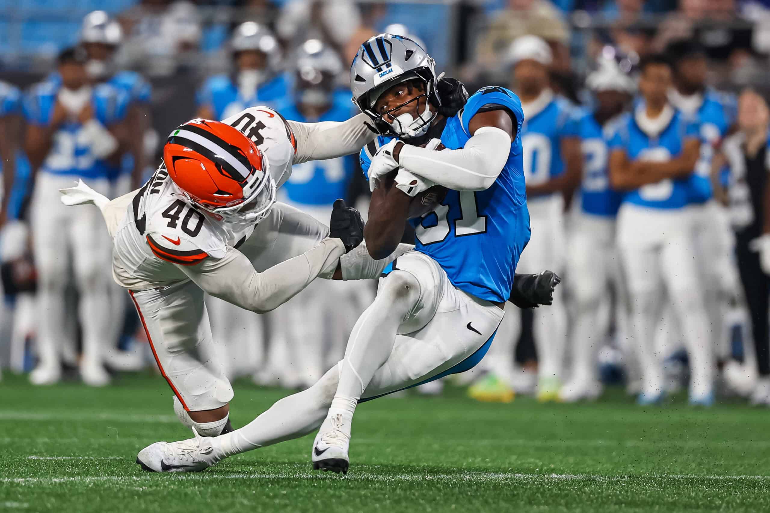 CHARLOTTE, NORTH CAROLINA - AUGUST 08: T.J. Luther #81 of the Carolina Panthers escapes a tackle by Nathaniel Watson #40 of the Cleveland Browns during the second half of an NFL Preseason 2025 game at Bank of America Stadium on August 08, 2025 in Charlotte, North Carolina.