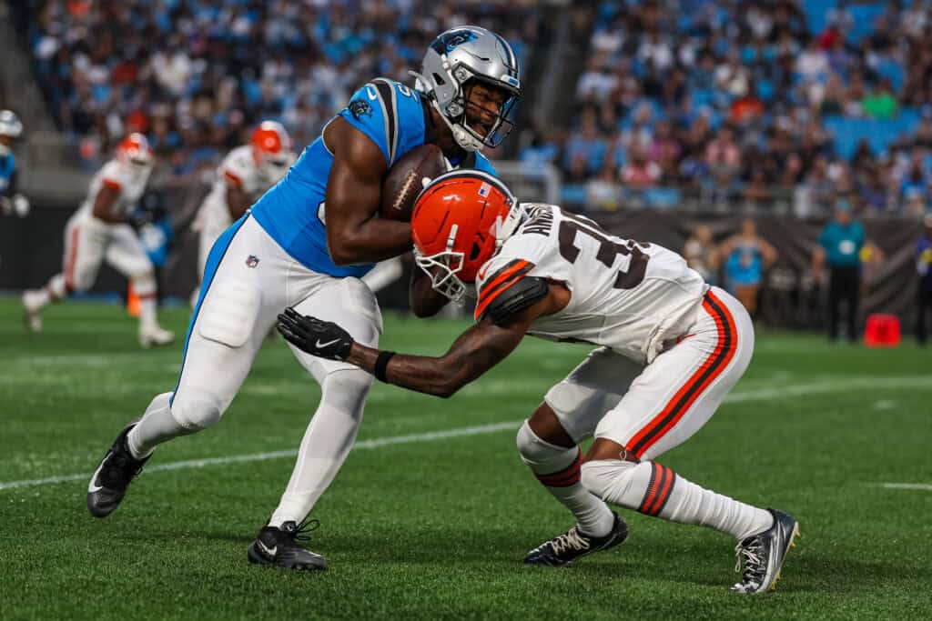 CHARLOTTE, NORTH CAROLINA - AUGUST 08: James Mitchell #85 of the Carolina Panthers collides with Chigozie Anusiem #35 of the Cleveland Browns during the first half of an NFL Preseason 2025 game at Bank of America Stadium on August 08, 2025 in Charlotte, North Carolina.