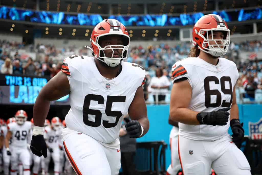 CHARLOTTE, NORTH CAROLINA - AUGUST 08: Guard Dartanyan Tinsley #65 and offensive tackle Lorenzo Thompson #69 of the Cleveland Browns run onto the field prior to the NFL Preseason 2025 game at Bank of America Stadium on August 08, 2025 in Charlotte, North Carolina.