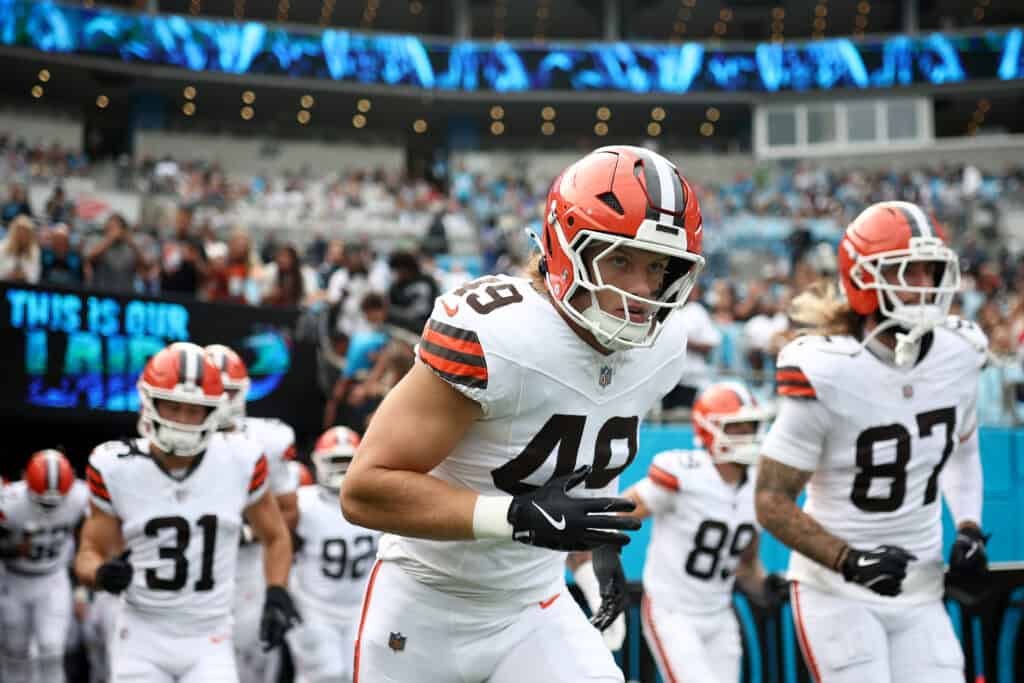 CHARLOTTE, NORTH CAROLINA - AUGUST 08: Linebacker Carson Schwesinger #49 and tight end Sal Cannella #87 of the Cleveland Browns run onto the field prior to the NFL Preseason 2025 game at Bank of America Stadium on August 08, 2025 in Charlotte, North Carolina