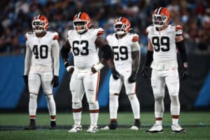 CHARLOTTE, NORTH CAROLINA - AUGUST 08: Linebacker Nathaniel Watson #40, defensive tackle Ralph Holley #63, linebacker Winston Reid #59, and defensive end Cameron Thomas #99 of the Cleveland Browns wait at the line of scrimmage in the second half during the NFL Preseason 2025 game against the Carolina Panthers at Bank of America Stadium on August 08, 2025 in Charlotte, North Carolina.