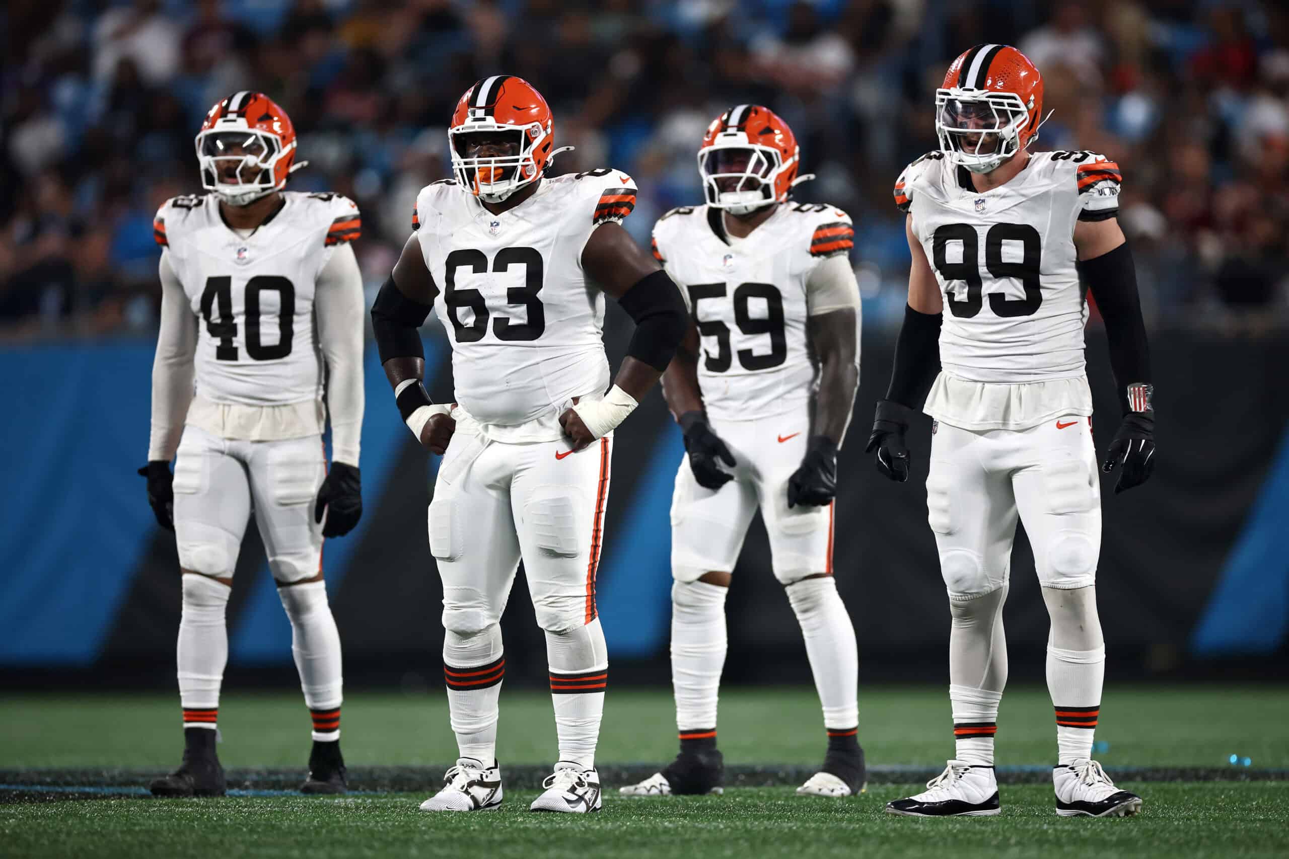 CHARLOTTE, NORTH CAROLINA - AUGUST 08: Linebacker Nathaniel Watson #40, defensive tackle Ralph Holley #63, linebacker Winston Reid #59, and defensive end Cameron Thomas #99 of the Cleveland Browns wait at the line of scrimmage in the second half during the NFL Preseason 2025 game against the Carolina Panthers at Bank of America Stadium on August 08, 2025 in Charlotte, North Carolina.