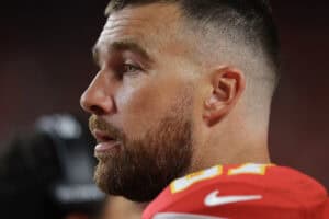 KANSAS CITY, MISSOURI - AUGUST 22: Travis Kelce #87 of the Kansas City Chiefs watches the game from the sidelines during the second quarter during the NFL Preseason 2025 game between Chicago Bears and Kansas City Chiefs at Arrowhead Stadium on August 22, 2025 in