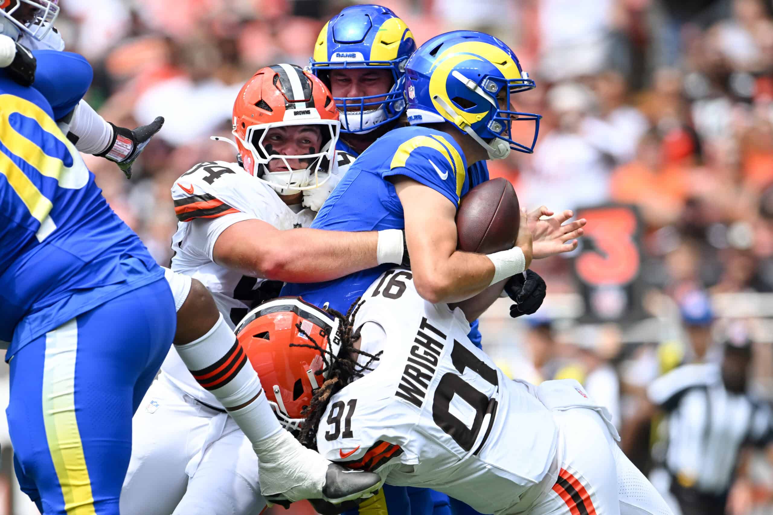CLEVELAND, OHIO - AUGUST 23: Mason Graham #94 and Alex Wright #91 of the Cleveland Browns sack Dresser Winn #4 of the Los Angeles Rams during the first quarter of an NFL Preseason 2025 game at Huntington Bank Field on August 23, 2025 in Cleveland, Ohio.