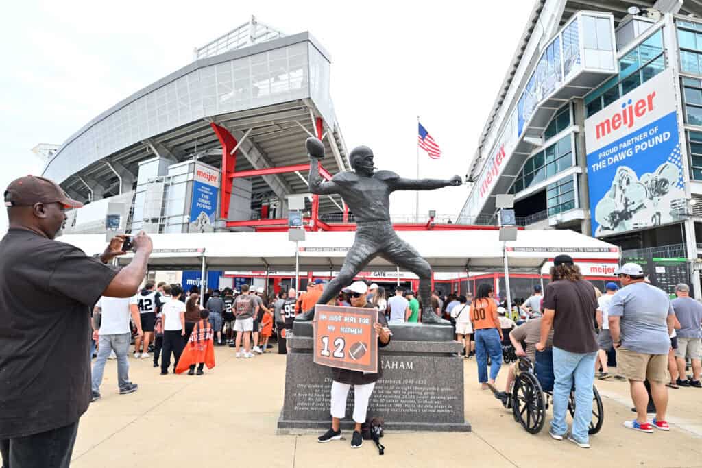 CLEVELAND, OHIO - AUGUST 23: Fans take a photo with a statue of Otto Graham outside Huntington Bank Field before the NFL Preseason 2025 game between Los Angeles Rams and Cleveland Browns on August 23, 2025 in Cleveland, Ohio.