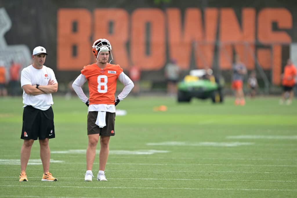 BEREA, OHIO - JULY 25: Offensive coordinator Tommy Rees and quarterback Kenny Pickett #8 of the Cleveland Browns look on during training camp at CrossCountry Mortgage Campus on July 25, 2025 in Berea, Ohio.