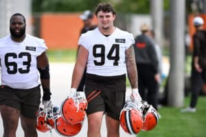 BEREA, OHIO - JUNE 10: Mason Graham #94 of the Cleveland Browns carries helmets as he walks off the field after Cleveland Browns mandatory minicamp at CrossCountry Mortgage Campus on June 10, 2025 in Berea, Ohio.