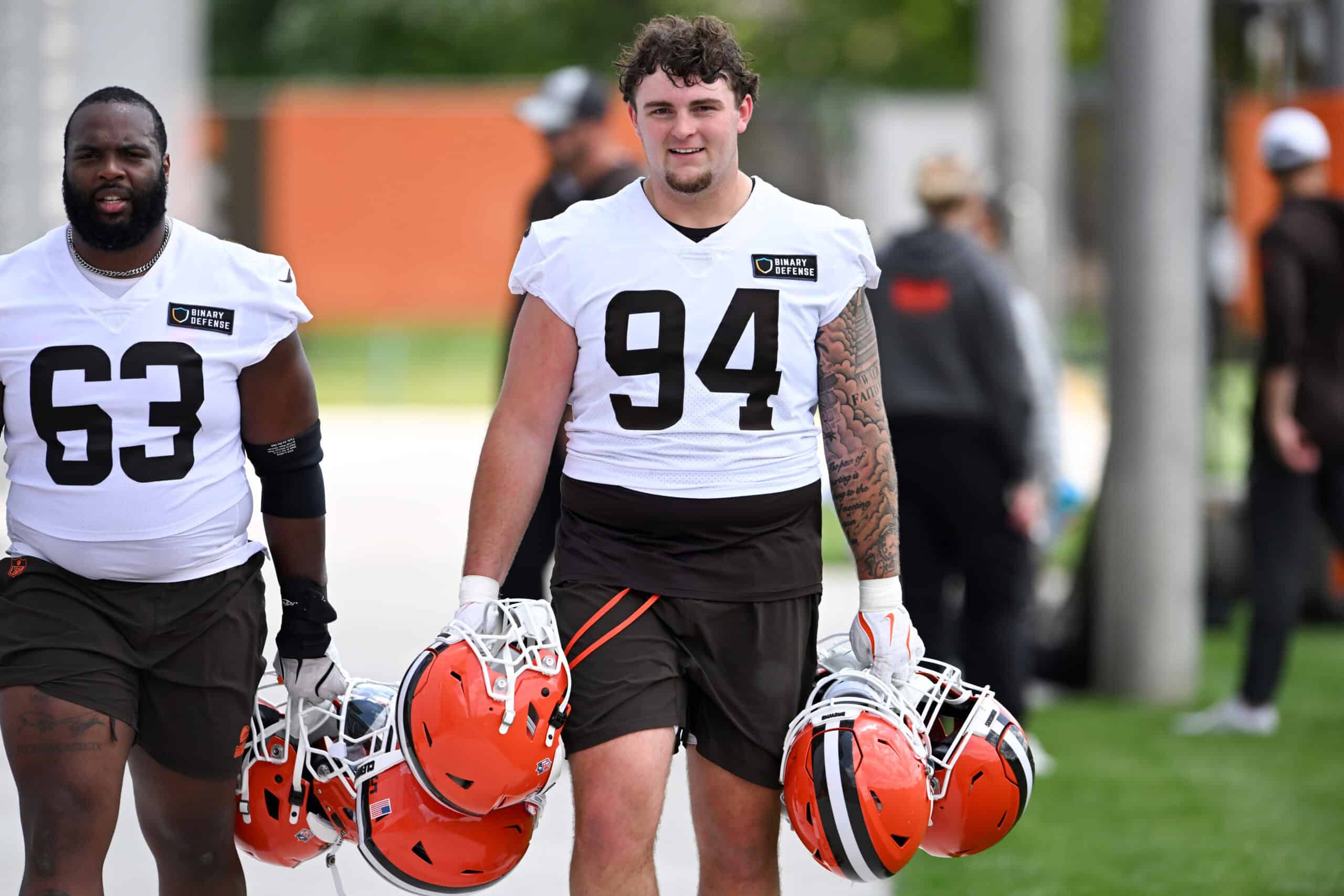 BEREA, OHIO - JUNE 10: Mason Graham #94 of the Cleveland Browns carries helmets as he walks off the field after Cleveland Browns mandatory minicamp at CrossCountry Mortgage Campus on June 10, 2025 in Berea, Ohio.