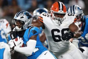 CHARLOTTE, NORTH CAROLINA - AUGUST 08: Wide receiver T.J. Luther #81 of the Carolina Panthers is tackled by defensive end Adin Huntington #66 of the Cleveland Browns in the second half during the NFL Preseason 2025 game at Bank of America Stadium on August 08, 2025 in Charlotte, North Carolina.