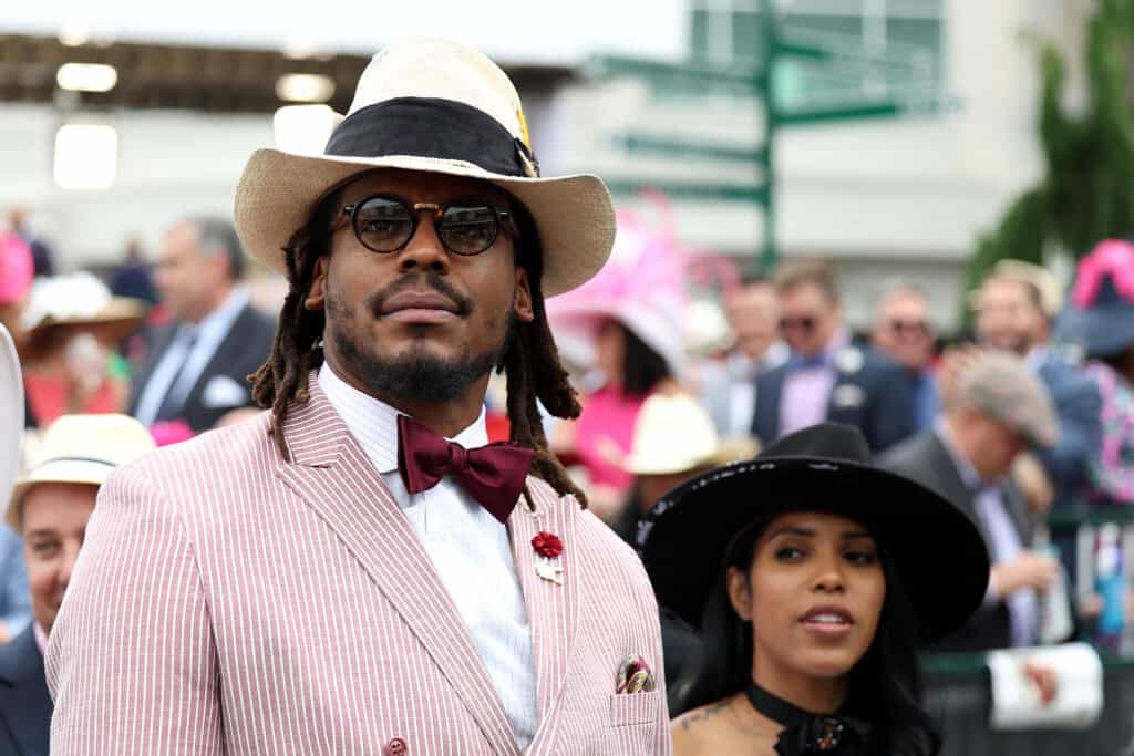 LOUISVILLE, KENTUCKY - MAY 07: NFL player Cam Newton watches an undercard race before the running of the 148th Kentucky Derby at Churchill Downs on May 07, 2022 in Louisville, Kentucky.