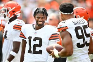 CLEVELAND, OHIO - AUGUST 23: Quarterback Shedeur Sanders #12 talks to defensive end Myles Garrett #95 of the Cleveland Browns before an NFL Preseason 2025 against the Los Angeles Rams at Huntington Bank Field on August 23, 2025 in Cleveland, Ohio.